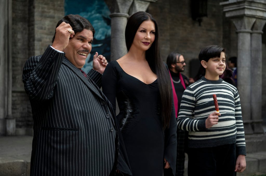 (L to R) Luis Guzmán as Gomez Addams, Catherine Zeta-Jones as Morticia Addams, Issac Ordonez as Pugsley Addams in episode 105 of Wednesday. Cr. © 2022
