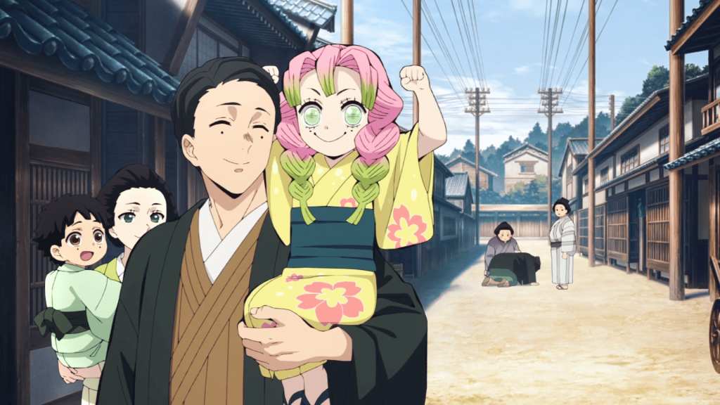 Demon Slayer: Kimetsu No Yaiba – Swordsmith Village Arc Ep. 10 "Love Hashira Mitsuri Kanroji" screenshot depicting young Mitsuri celebrating with her family about beating a sumo wrestler in an eating contest.