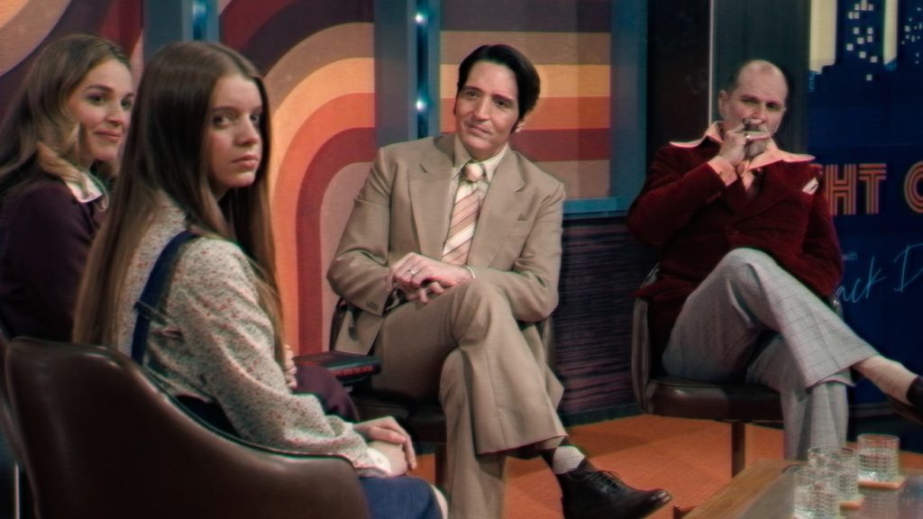Late Night With The Devil David Dastmalchian as Jack Delroy looks at guests on his show.