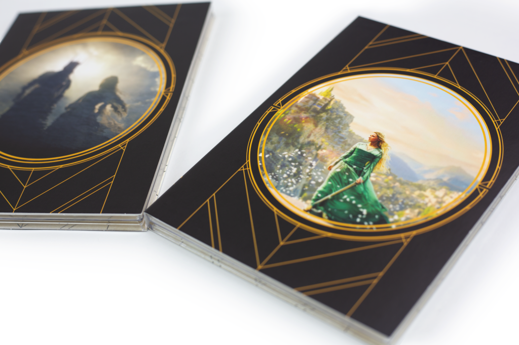 Close up of art on dust jackets of CD covers in Rings of Power soundtrack collection