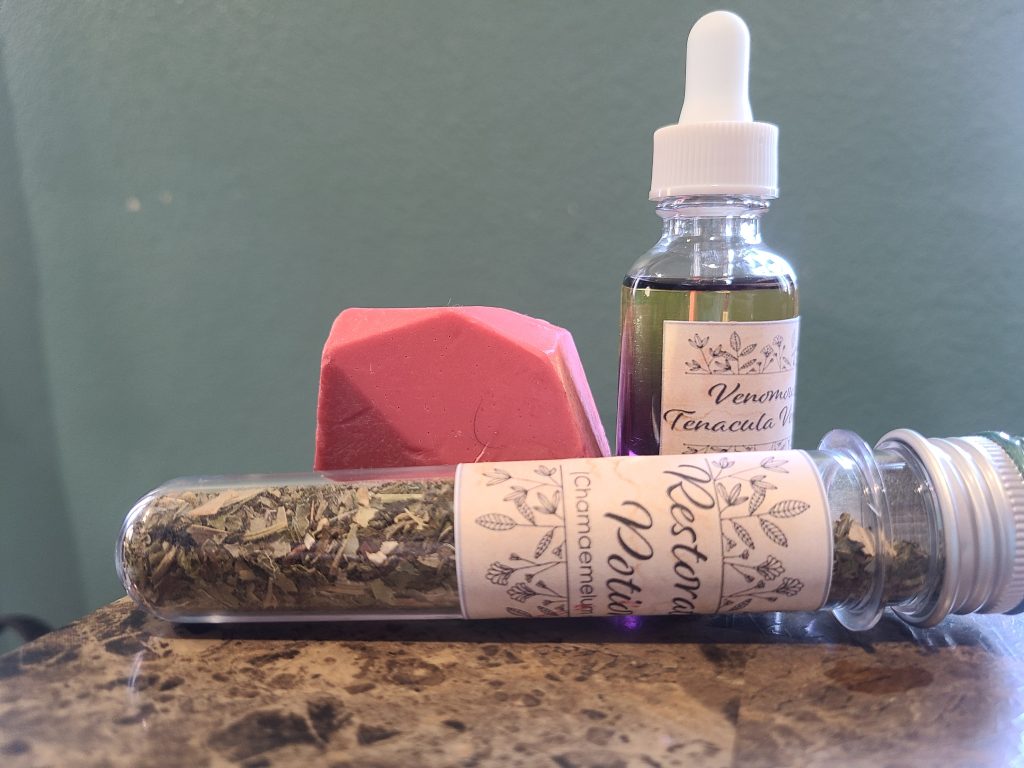 Alchemy for the Skin's Herbology 102 box. These are the Venomous Tentacula Venom, restorative tea, and philosopher's stone.