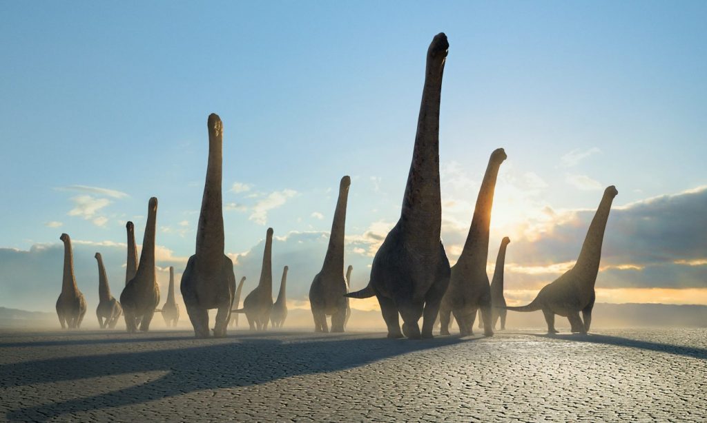 "Prehistoric Planet" screenshot showing a herd of Dreadnoughtus on a desert plain.